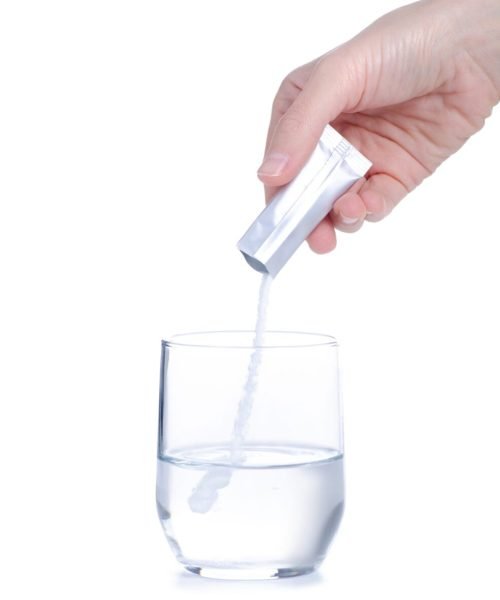 Female,Hand,Holding,Glass,Of,Water,Powder,Medicine,On,White